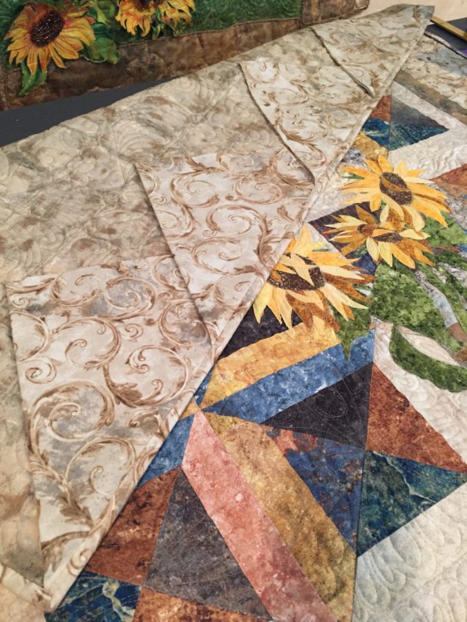 Image of 48-inch quilt with prairie points.