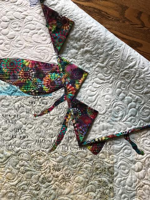 Image of back of quilt with prairie points.