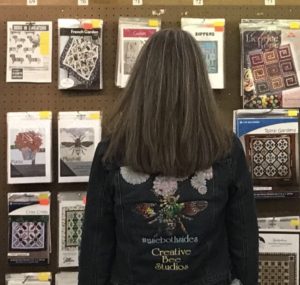 Karla Kiefner with patterns at quilt show week in Hancock's of Paducah.