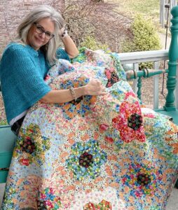 Image of Karla with queen's palace quilt