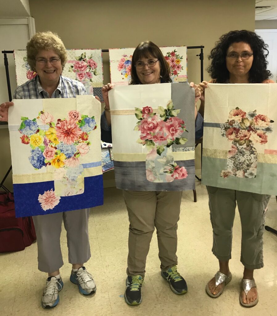 Image of Three Twilight Quilters with Quilts