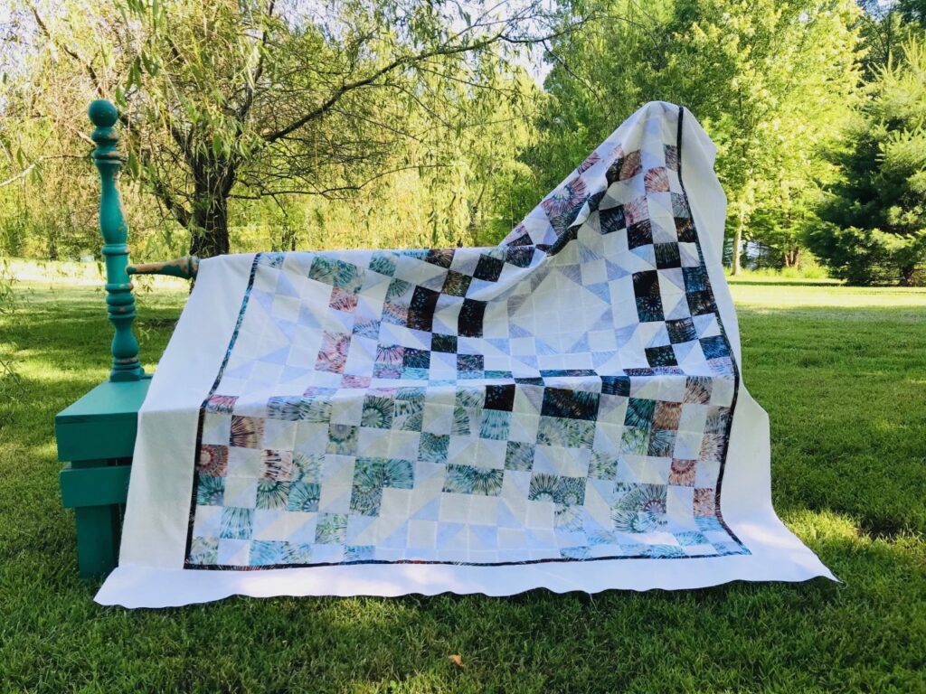 Image of Treasures quilt pattern using three new fabrics in this one-block quilt.