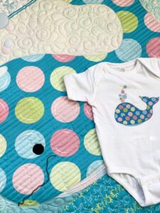 image of quilt and onesie