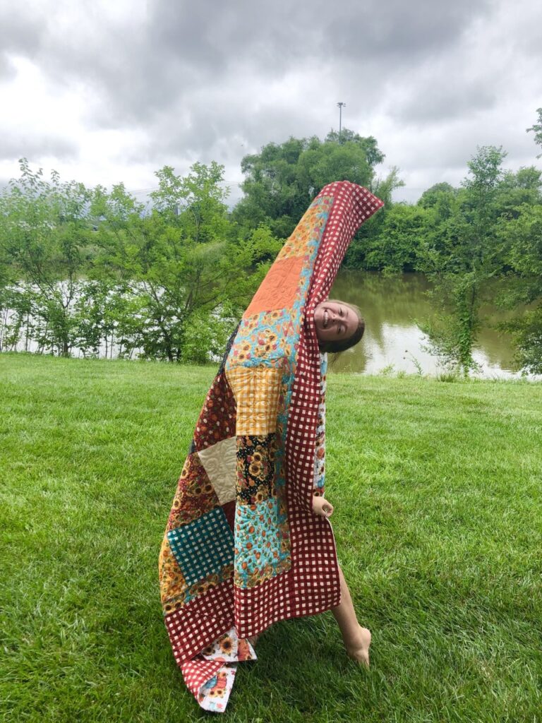 Image of Paige holding quilt