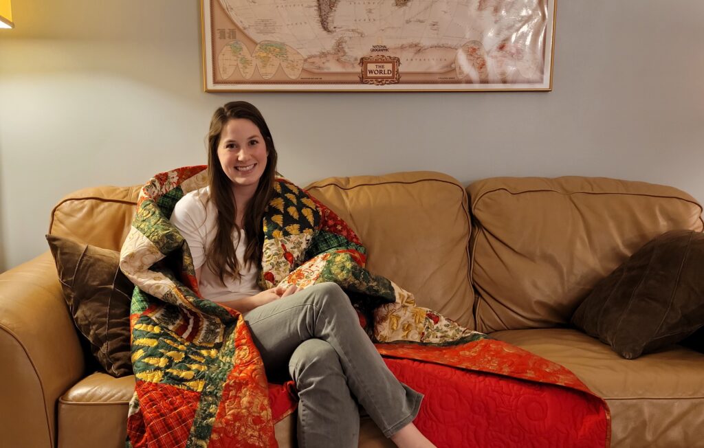 Julia showing her Christmas quilting throw