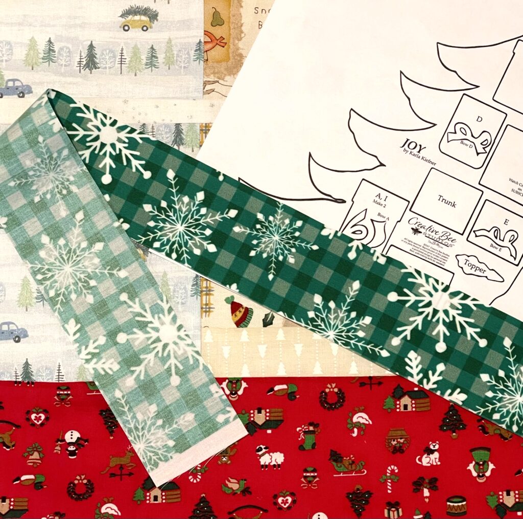 Both sides of focus fabric shown with Christmas tree applique template.